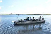 Photo of romantic flat boat cruise across a lake on safari in Africa